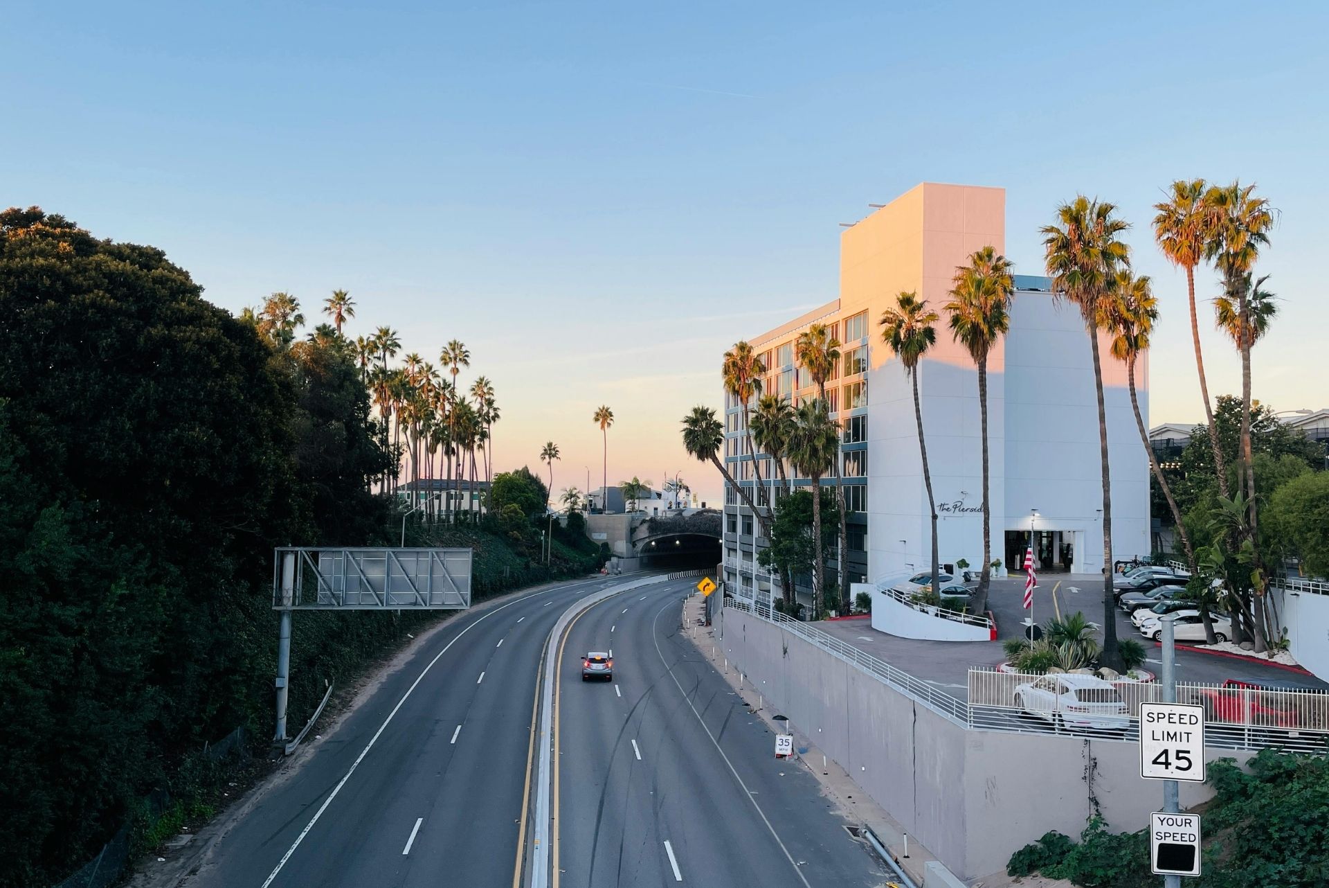 A scenic view of a Southern California highway at sunset, highlighting the local service area