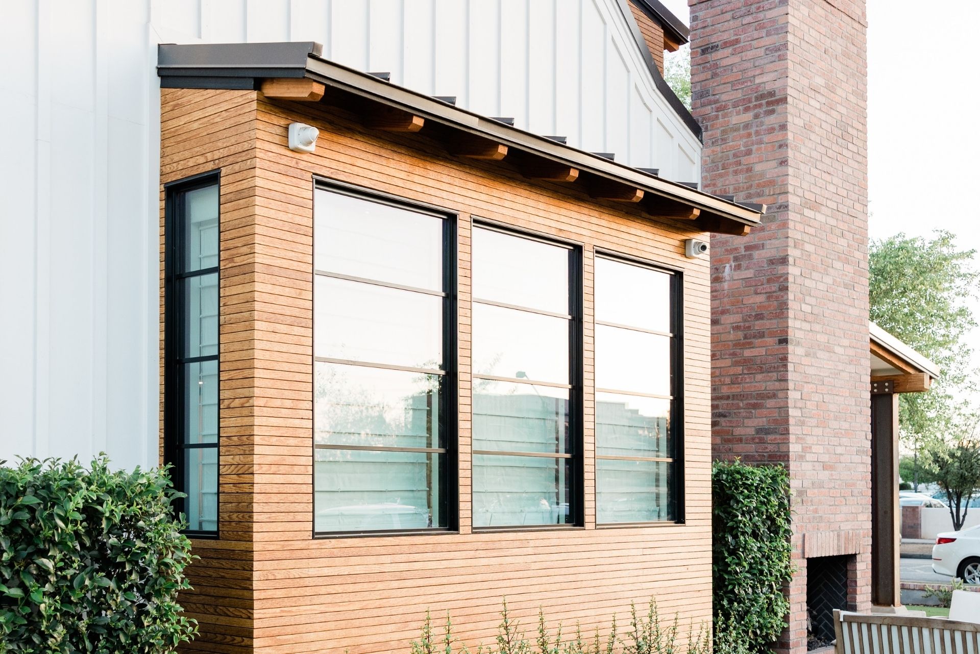 Exterior view of a modern Santa Clarita home addition with wood siding and large windows