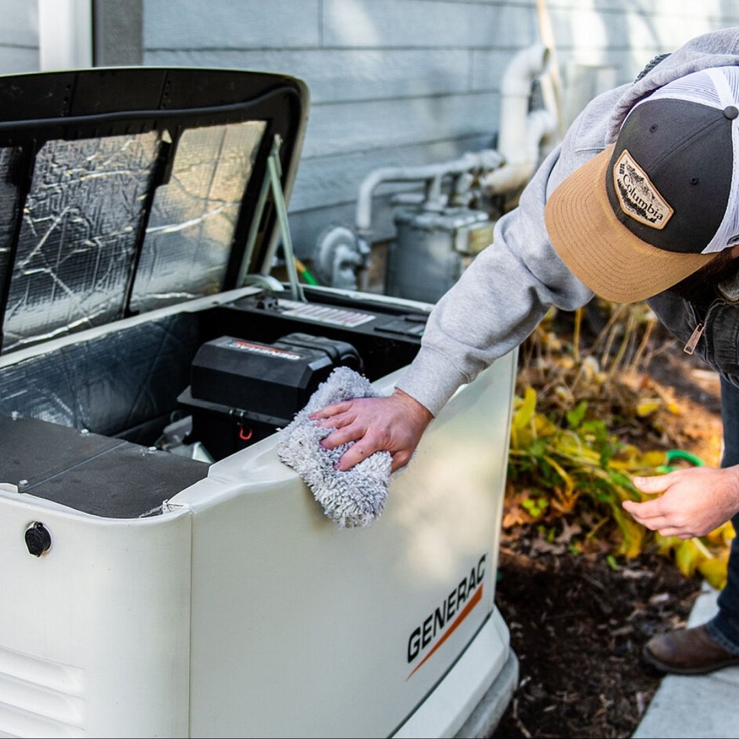 a man performing maintenance on a generator